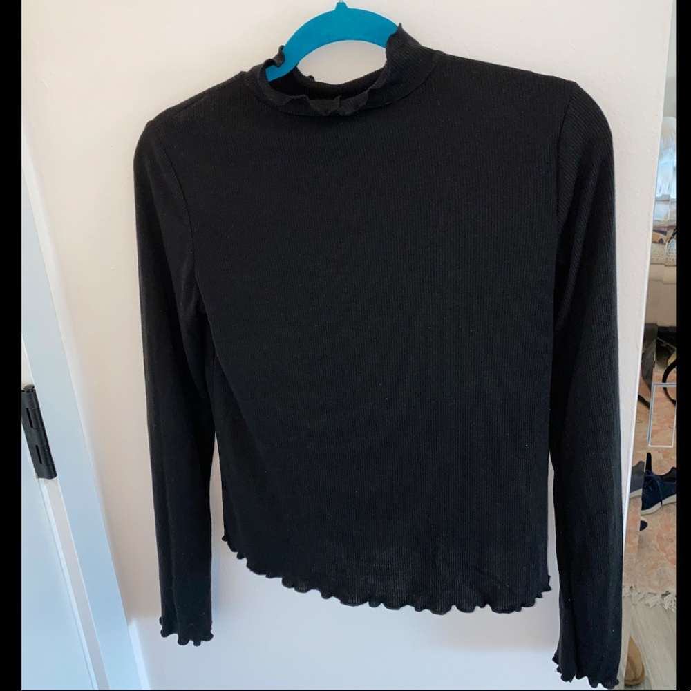 Black turtle neck with frill sleeve and neck